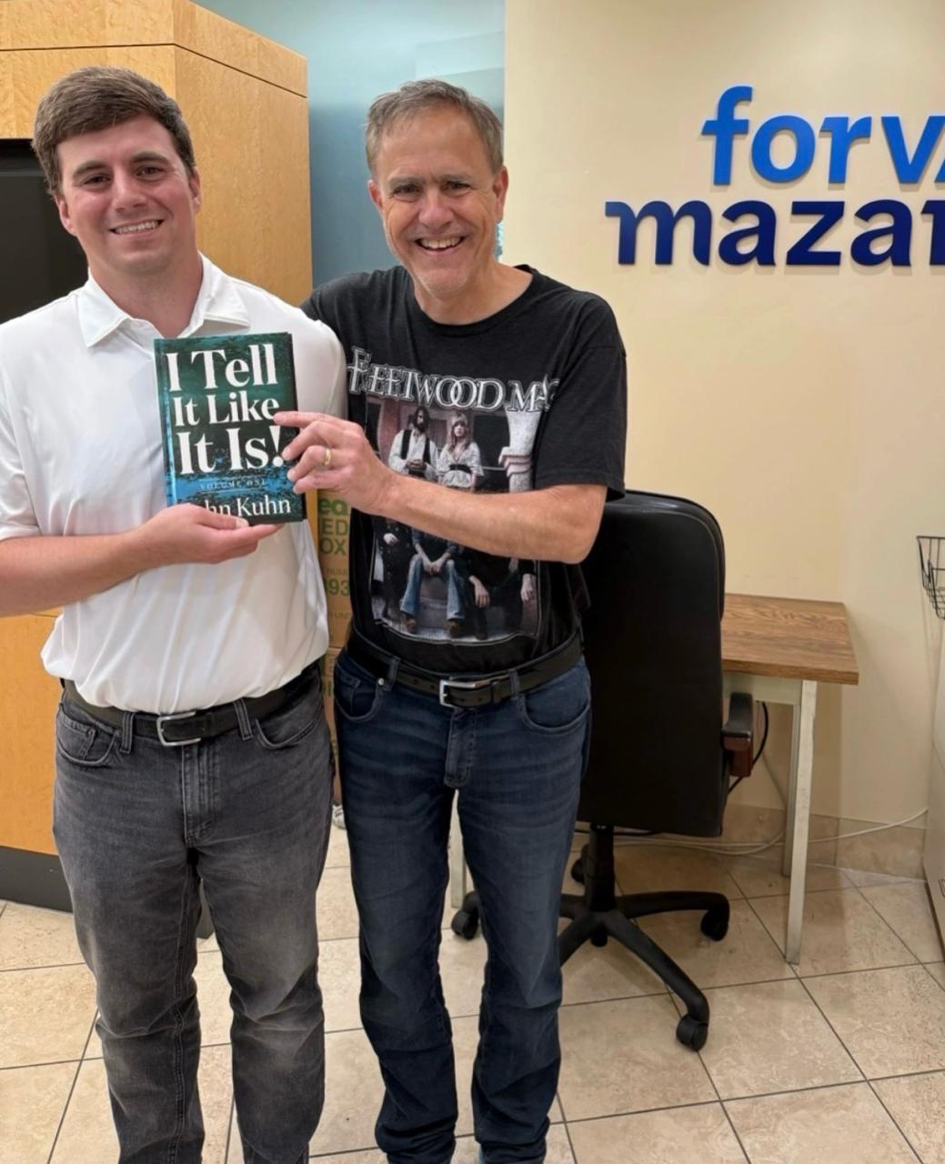 John Kuhn at dealership with his book