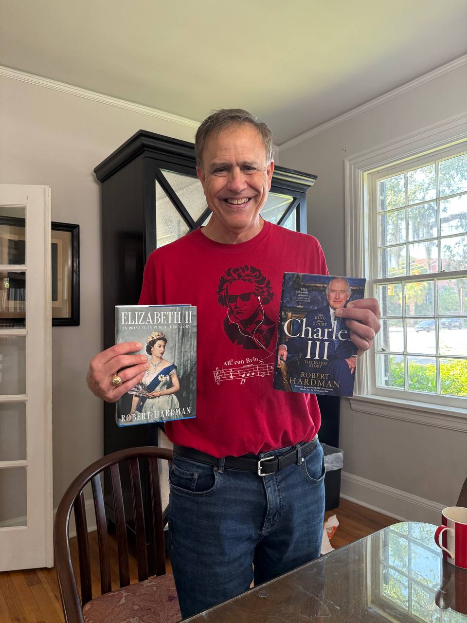 John Kuhn holding Elizabeth II and Charles III books