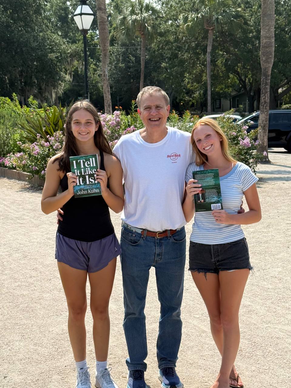 John Kuhn with two readers holding his book