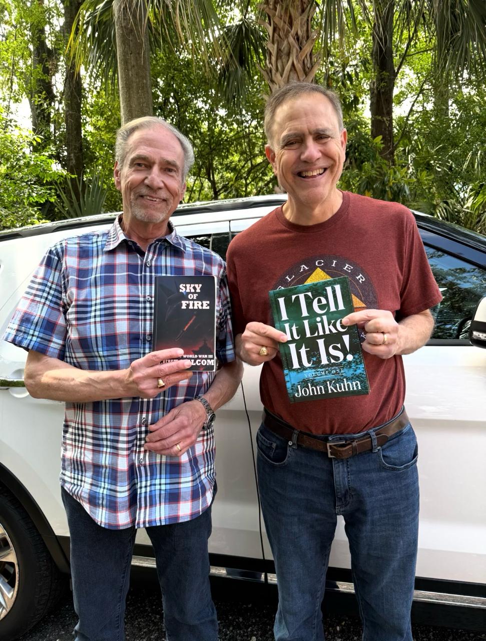 John Kuhn with fellow author by a white car